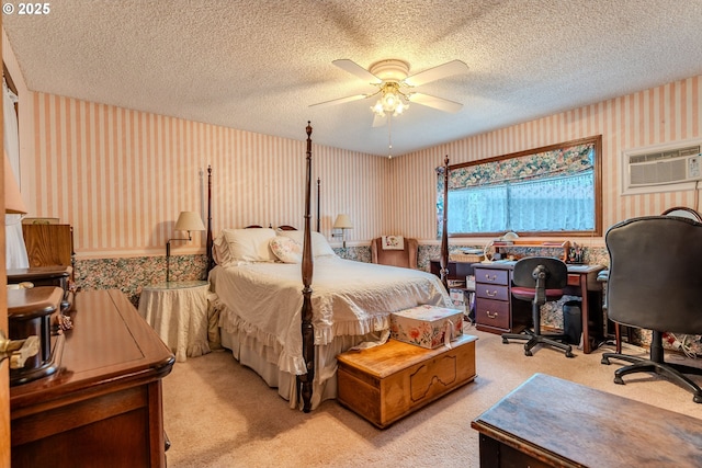 bedroom with light colored carpet, ceiling fan, a textured ceiling, a wall mounted air conditioner, and wallpapered walls