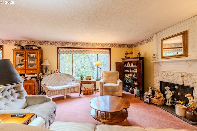 living area with carpet, a textured ceiling, and a stone fireplace