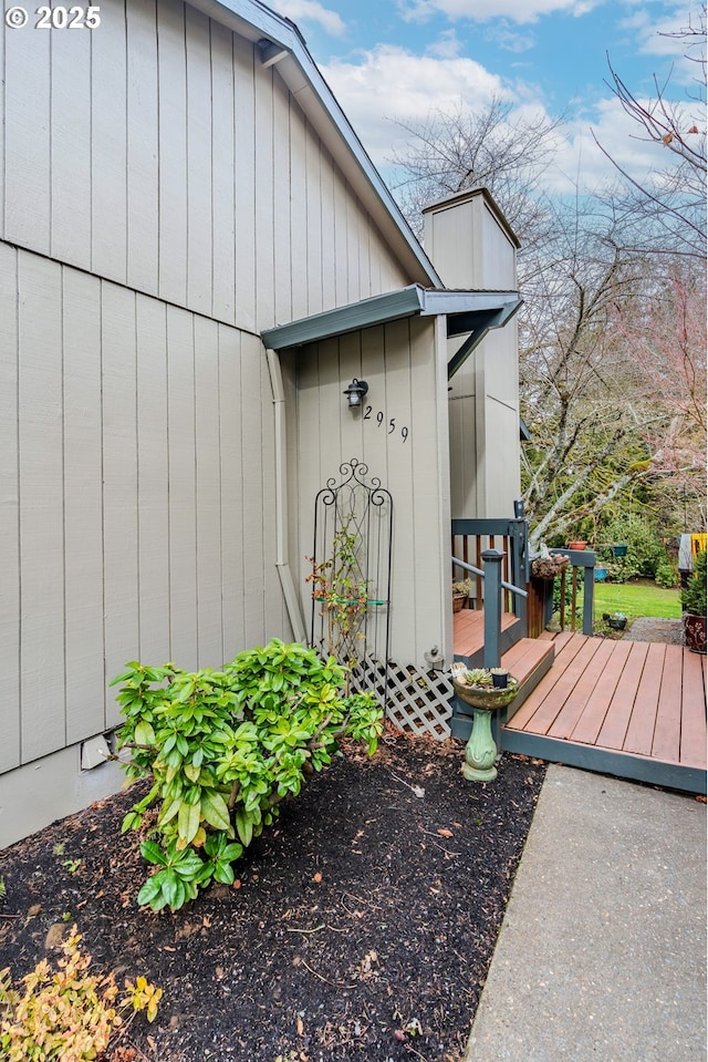 entrance to property with a chimney and a deck