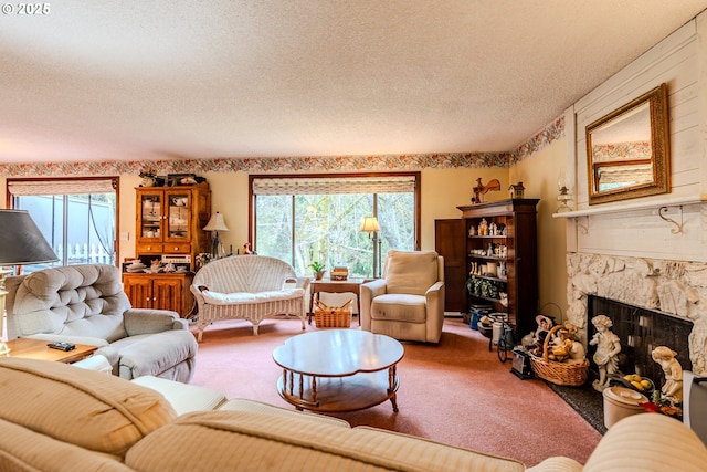 carpeted living room featuring a textured ceiling, a wealth of natural light, and a stone fireplace