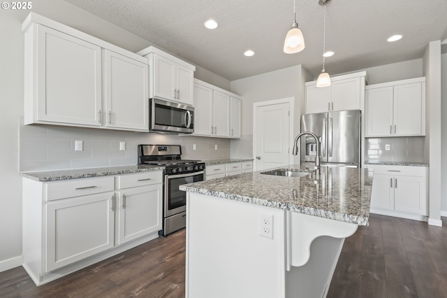 142 N 35th Pl, Cornelius, OR 97124 - kitchen with appliances with stainless steel finishes, a sink, dark wood-type flooring, white cabinets, and recessed lighting