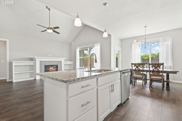 142 N 35th Pl, Cornelius, OR 97124 - kitchen featuring stainless steel dishwasher, a sink, dark wood finished floors, decorative light fixtures, and a textured ceiling