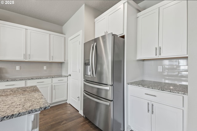 142 N 35th Pl, Cornelius, OR 97124 - kitchen with stainless steel refrigerator with ice dispenser, dark wood-style floors, white cabinets, decorative backsplash, and a textured ceiling
