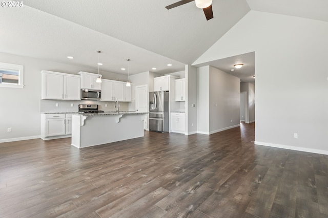 142 N 35th Pl, Cornelius, OR 97124 - unfurnished living room featuring a ceiling fan, a sink, baseboards, recessed lighting, and dark wood-type flooring