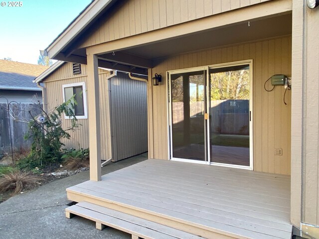 view of home's exterior featuring fence and a shingled roof