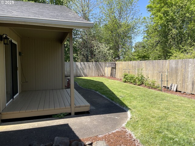 view of patio / terrace with an outdoor structure, fence, and a storage shed