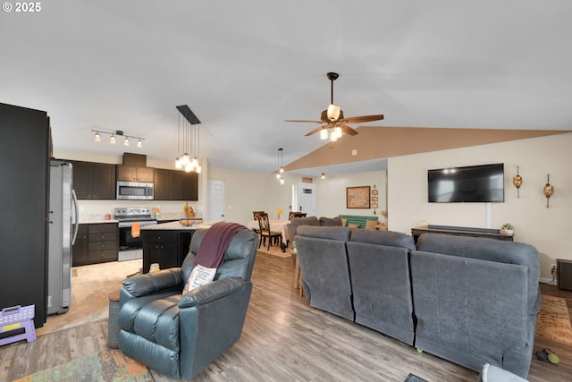 living room with light wood-type flooring, a ceiling fan, and lofted ceiling