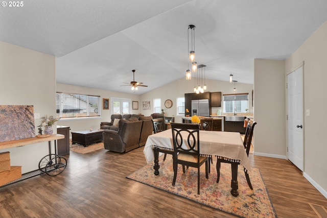dining space with vaulted ceiling, visible vents, dark wood-type flooring, baseboards, and ceiling fan