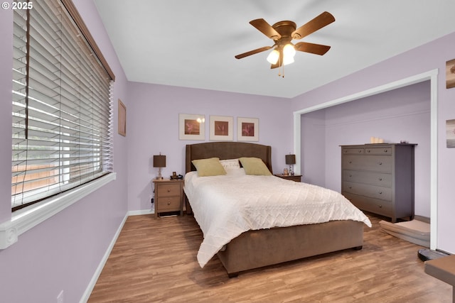 bedroom with baseboards, wood finished floors, and ceiling fan
