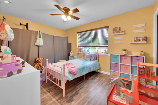 bedroom with wood finished floors, ceiling fan, and baseboards