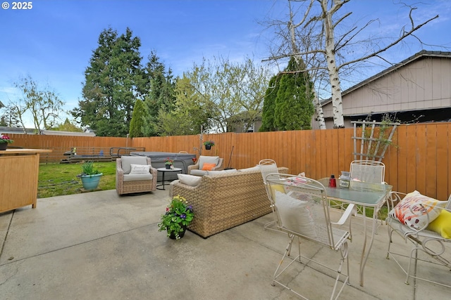 view of patio / terrace with a fenced backyard, an outdoor living space, and outdoor dining space