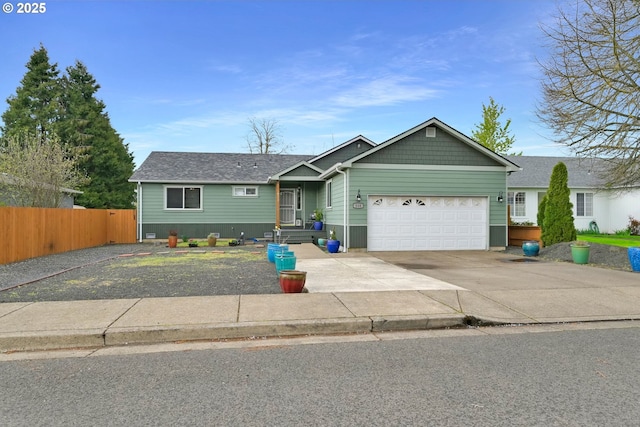 single story home with fence, driveway, and a garage