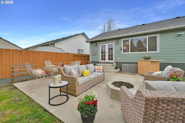 view of patio featuring an outdoor living space with a fire pit, entry steps, french doors, and a fenced backyard