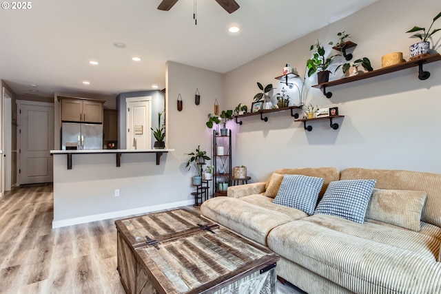 living room with light wood-type flooring, ceiling fan, baseboards, and recessed lighting