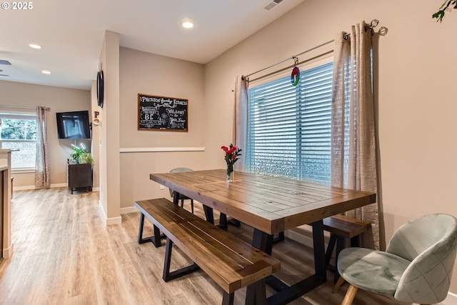 dining space with light wood-style floors, recessed lighting, and baseboards