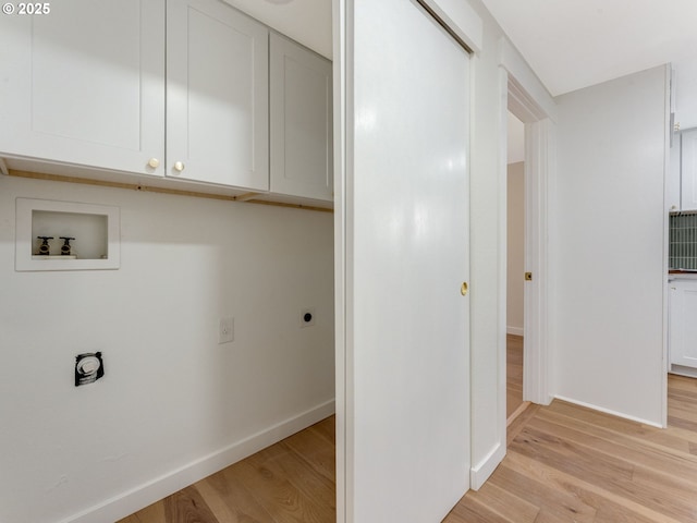 laundry room featuring hookup for a washing machine, hookup for an electric dryer, cabinet space, and light wood finished floors