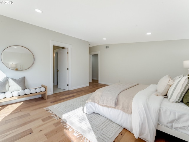 bedroom with baseboards, light wood-type flooring, visible vents, and recessed lighting