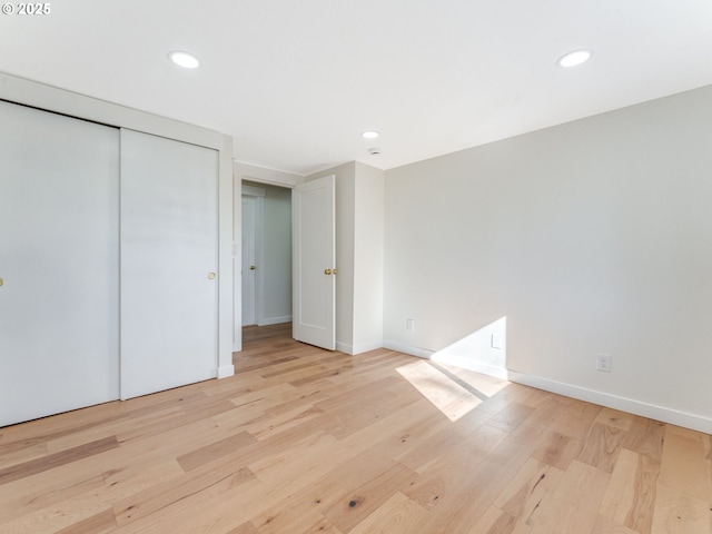 unfurnished bedroom with baseboards, wood finished floors, and recessed lighting