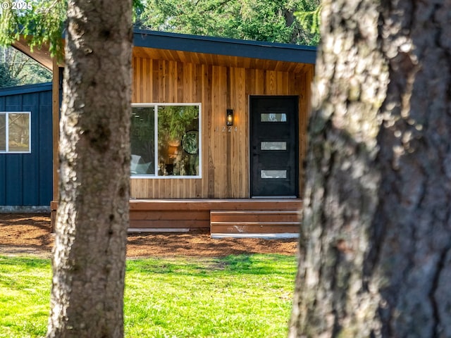 entrance to property featuring board and batten siding