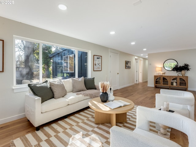 living room featuring light wood-style floors, recessed lighting, and baseboards