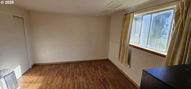 33261 Ophir Rd, Gold Beach, OR 97444 - spare room featuring plenty of natural light, wood finished floors, baseboards, heating unit, and crown molding