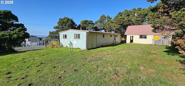 33261 Ophir Rd, Gold Beach, OR 97444 - back of house with a lawn and an outbuilding
