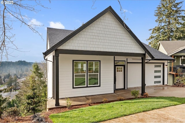 737 SE Forest Glen Rd, Estacada, OR 97023 - view of front of house with a garage, driveway, a shingled roof, and covered porch