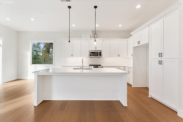 737 SE Forest Glen Rd, Estacada, OR 97023 - unfurnished living room with vaulted ceiling, a ceiling fan, light wood-style floors, a tile fireplace, and visible vents