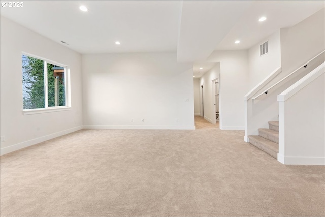 737 SE Forest Glen Rd, Estacada, OR 97023 - unfurnished living room with light colored carpet, stairs, visible vents, and recessed lighting
