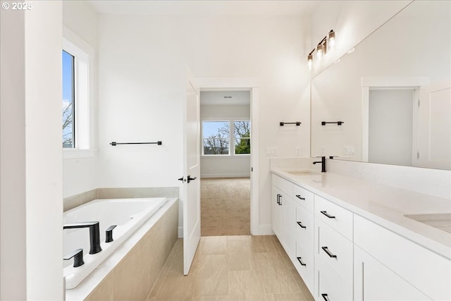 737 SE Forest Glen Rd, Estacada, OR 97023 - full bath with tiled tub, a sink, double vanity, and baseboards
