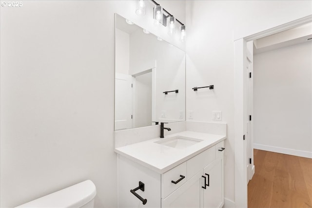 737 SE Forest Glen Rd, Estacada, OR 97023 - bathroom with baseboards, wood finished floors, vanity, and toilet