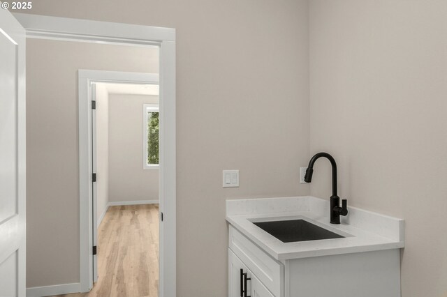 59787 Kimmell Ln, Saint Helens, OR 97051 - clothes washing area with a sink and light wood-style flooring