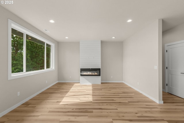 59787 Kimmell Ln, Saint Helens, OR 97051 - unfurnished living room with light wood-type flooring, recessed lighting, baseboards, and a fireplace