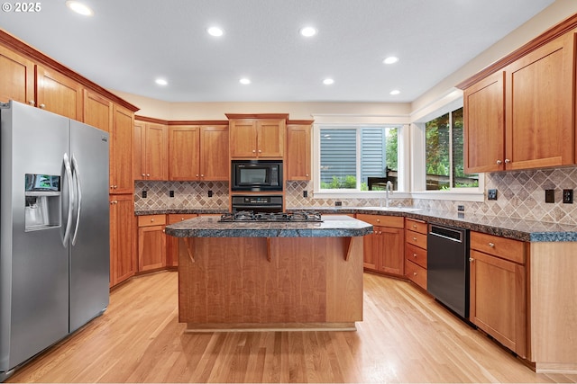 3578 NW Gerritz Ter, Portland, OR 97229 - kitchen with stainless steel appliances, light wood-type flooring, a sink, backsplash, and a kitchen island