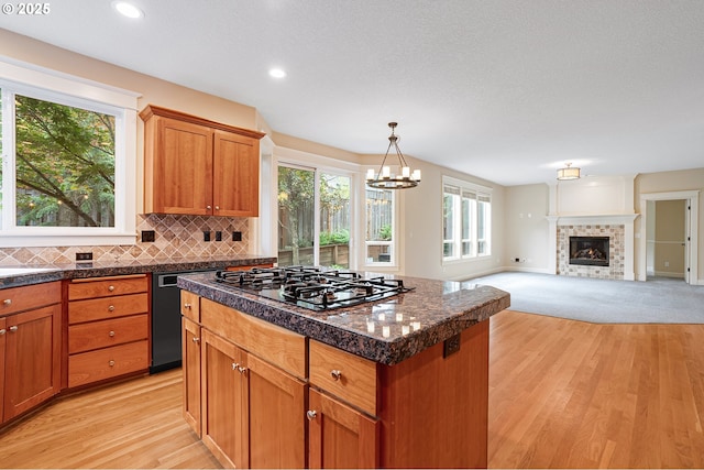 3578 NW Gerritz Ter, Portland, OR 97229 - kitchen featuring gas stovetop, light wood-style floors, a kitchen island, dishwashing machine, and a chandelier