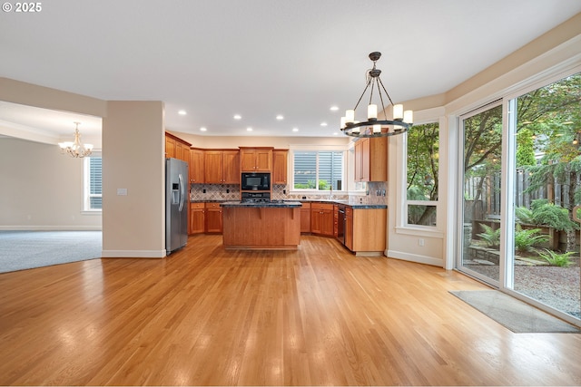 3578 NW Gerritz Ter, Portland, OR 97229 - kitchen with a chandelier, black microwave, stainless steel fridge, plenty of natural light, and recessed lighting