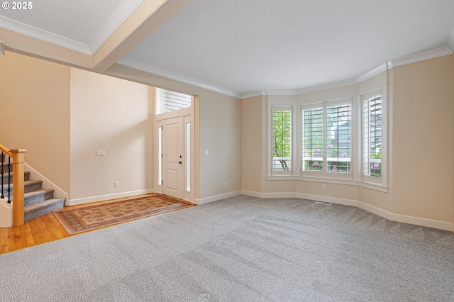 3578 NW Gerritz Ter, Portland, OR 97229 - carpeted foyer entrance featuring crown molding, stairs, baseboards, and a textured ceiling