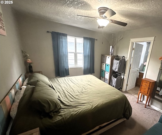 carpeted bedroom with ceiling fan and a textured ceiling