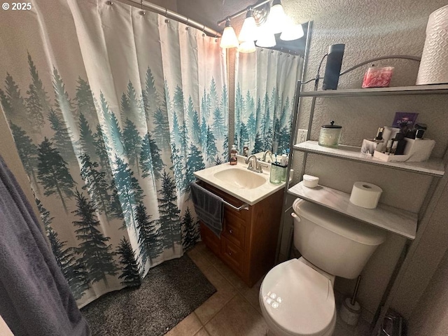 bathroom with tile patterned floors, toilet, and vanity