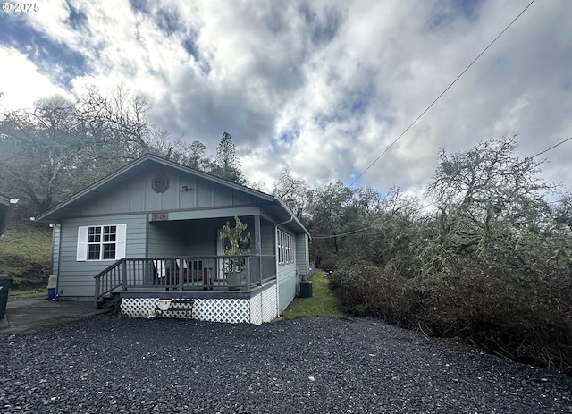 bungalow-style home featuring a porch and central AC unit