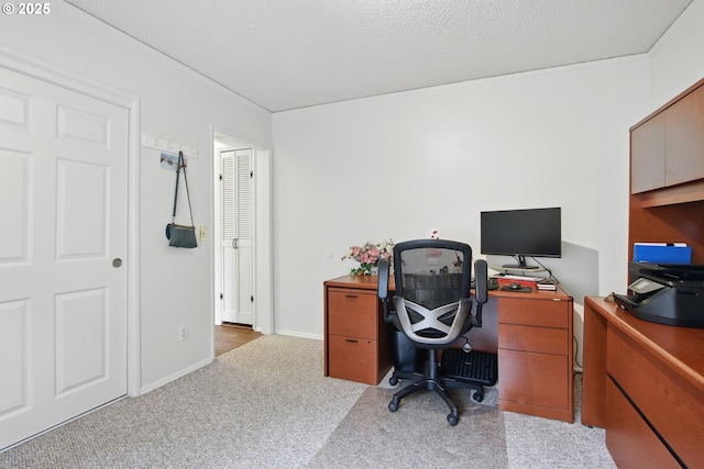 office featuring a textured ceiling and carpet
