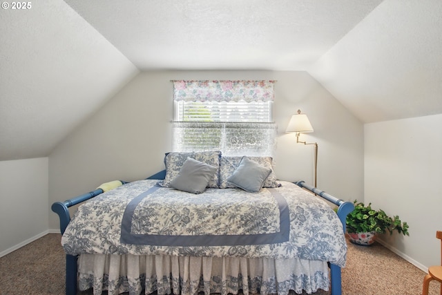 carpeted bedroom with lofted ceiling, a textured ceiling, and baseboards
