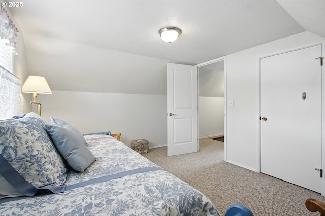 bedroom featuring lofted ceiling, carpet flooring, and baseboards
