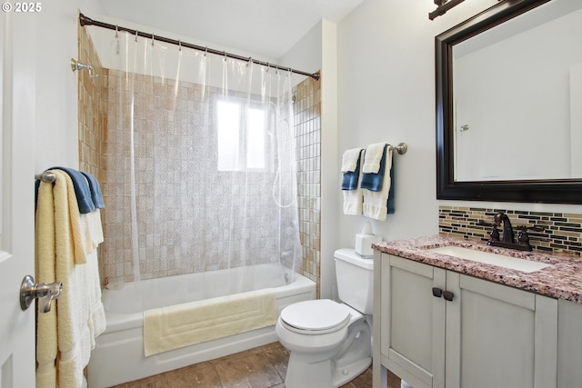 full bathroom featuring shower / bath combo, vanity, backsplash, and toilet