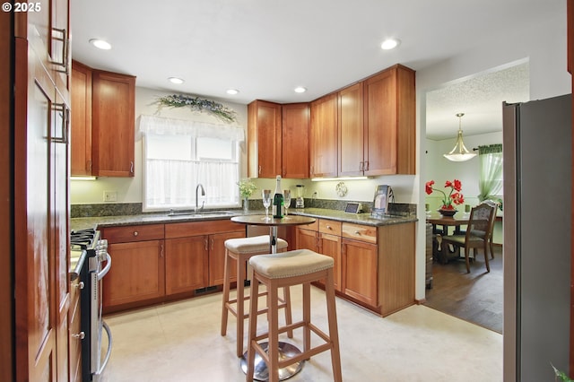 kitchen with light floors, recessed lighting, stainless steel appliances, and a sink