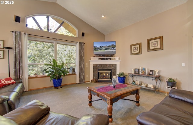 living area with carpet, high vaulted ceiling, a fireplace, and baseboards