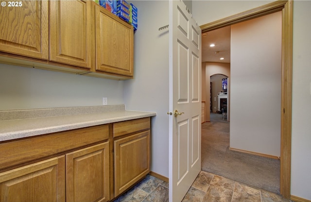 interior space featuring baseboards, recessed lighting, and stone finish flooring