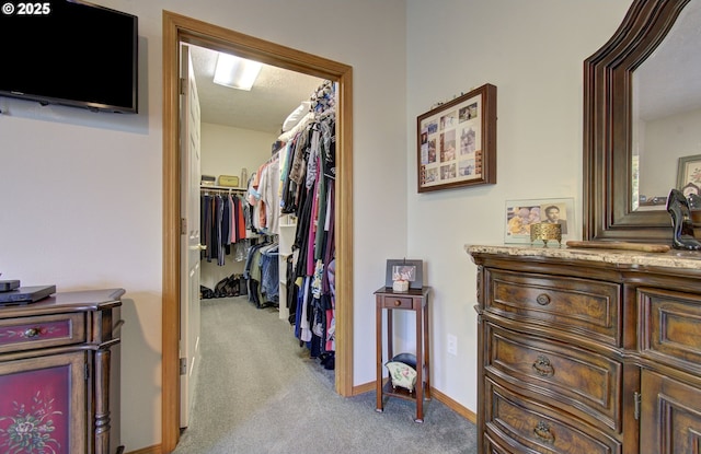 corridor with carpet and baseboards