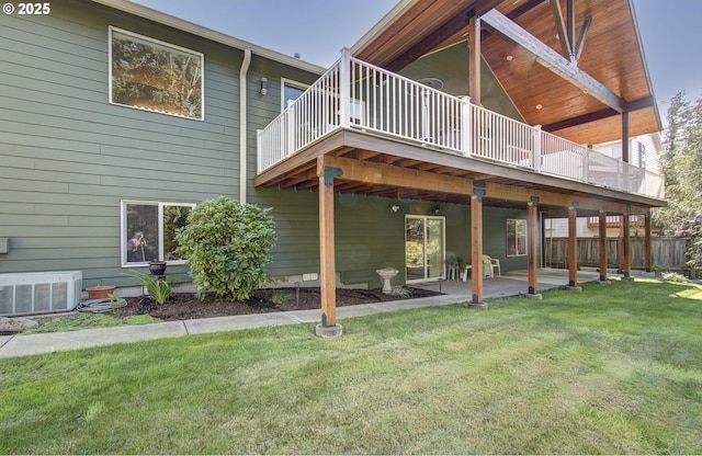 back of house featuring a patio, a yard, a wooden deck, and cooling unit