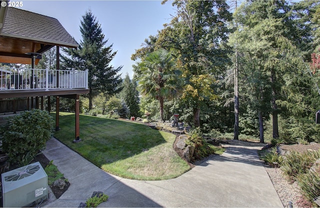 view of grassy yard featuring a deck